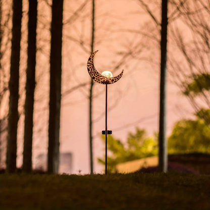 Solar tuinlamp van ijzer verlicht een tuinpad in de avond