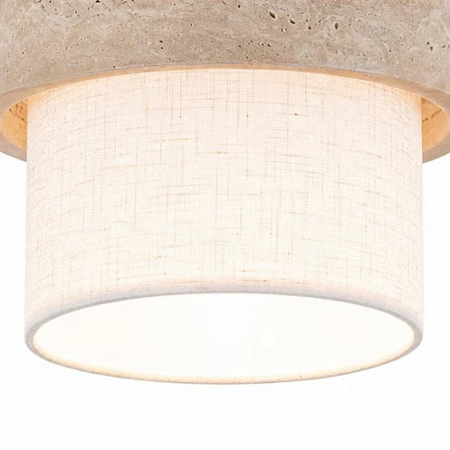 Hanglamp van travertin en stof boven een tafel in een rustig interieur