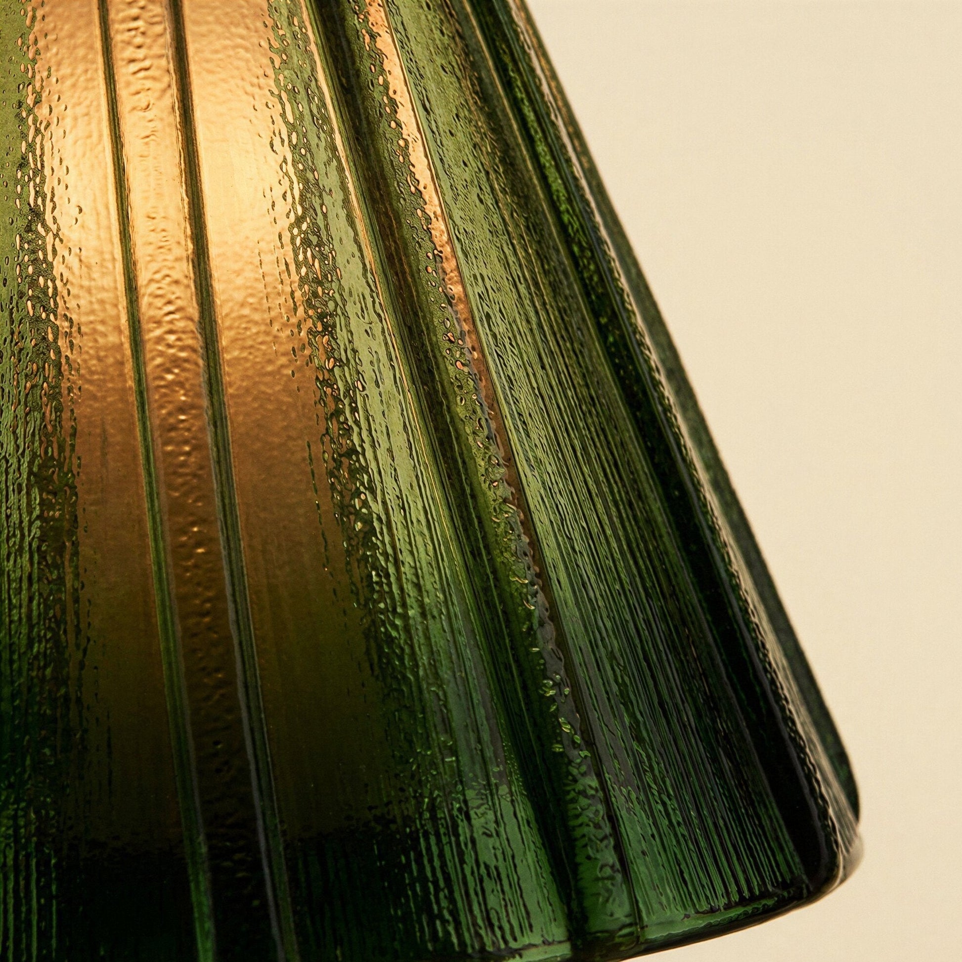 Groene geplooide glazen tafellamp op messing voet met warm licht