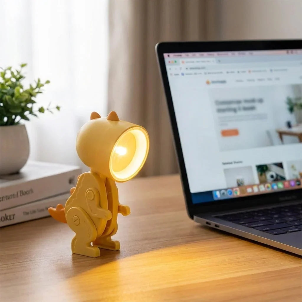 opvouwbare dinosaurus-bureaulamp met klem op een kinderbureau